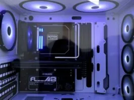 A beautifully clean, minimalist PC build with a back-connect motherboard visible through a clear tempered glass side panel, showcasing excellent cable management and subtle lighting. The interior is largely black and white, with no distracting RGB elements.