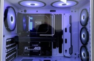 Minimalist Motherboard Designs: The Stealth Revolution in PC Building A beautifully clean, minimalist PC build with a back-connect motherboard visible through a clear tempered glass side panel, showcasing excellent cable management and subtle lighting. The interior is largely black and white, with no distracting RGB elements.