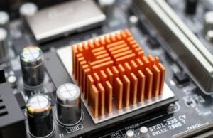 Motherboard Durability and Longevity: A Deep Dive into Quality A close-up of a modern motherboard, highlighting solid capacitors and VRM heatsinks for enhanced durability and longevity.