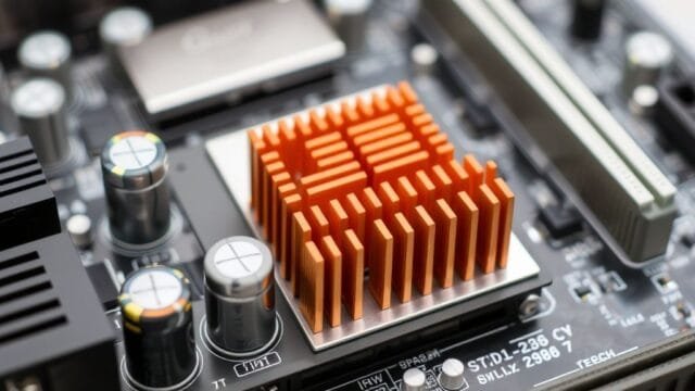 Motherboard Durability and Longevity: A Deep Dive into Quality A close-up of a modern motherboard, highlighting solid capacitors and VRM heatsinks for enhanced durability and longevity.