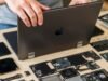 Right to Repair Laptops: Shaping Tomorrow’s Upgradable Tech A close-up of a person unscrewing the back of a modern, modular laptop, with various components laid out on a table, highlighting the ease of repair for Right to Repair laptops.
