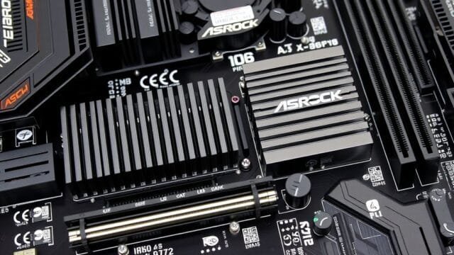 ASRock X870E Taichi OCF: Unleash AM5 Overclocking Power A close-up of the ASRock X870E Taichi OCF motherboard's VRM section with large heatsinks and numerous power stages.