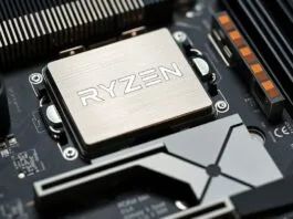 A close-up shot of an AMD AM5 motherboard with a Ryzen CPU installed, showcasing the VRM heatsinks and PCIe 5.0 M.2 slot.