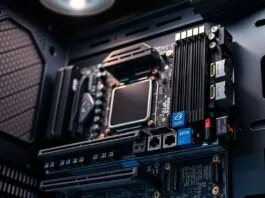 A close-up shot of an ASUS BTF motherboard with all its rear connectors clearly visible, mounted in a compatible PC case.