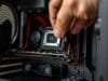 SFF PC Build Guide: Unleashing Power in Compact Rigs A close-up shot of hands carefully installing a component into a cramped SFF PC case, emphasizing the precision and tight space.