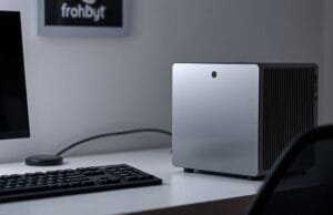 Small Form Factor PCs: Micro-ATX & Mini-ITX Explosion Guide A sleek, modern Small Form Factor PC setup on a minimalist desk, showcasing its compact size next to a monitor and keyboard.