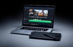 Laptops for Video Editing: Ultimate Showdown for Creators A sleek, open laptop displaying video editing software on screen, with a graphics tablet and stylus beside it. The screen shows a timeline with multiple video tracks.