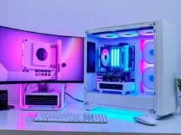 A stunning all-white PC build with vibrant RGB lighting emanating from the components, showcased within a sleek, minimalist desk setup.