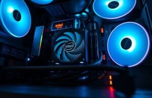 All-Intel PC: Finally Worth It? The Truth. An eye-level shot of a sleek, modern PC build showcasing an Intel Core CPU cooler and an Intel Arc discrete GPU, illuminated by subtle RGB lighting. This serves as the featured image for an all-Intel PC.