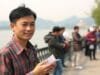Jack Ma Journey: From Rejection to Global Empire Jack Ma as a young man practicing English with foreign tourists by West Lake, Hangzhou. This image captures an important part of the early Jack Ma journey.