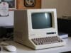 Macintosh Era: How It Changed Computing Forever Original Macintosh 128K on a desk, showcasing its compact, all-in-one design and integrated screen